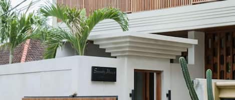 A modern building with a sign reading "Serenity House."