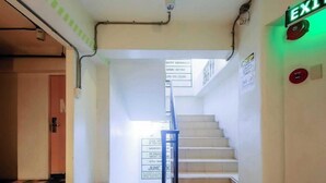 A staircase with a sign indicating smoking is prohibited. - Junction Hostels (Makati)