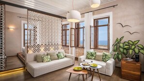 A modern living room with a sofa set, a coffee table, and a plant.