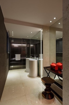 A modern bathroom with a glass partition, two sinks, a mirror, and a small wooden table. - H Hotel Seocho (Seoul)