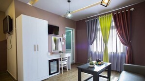 A compact living space with a kitchenette, a dining area, and a seating area. - Ken Apos S House Backpackers Downtown (Da Lat)