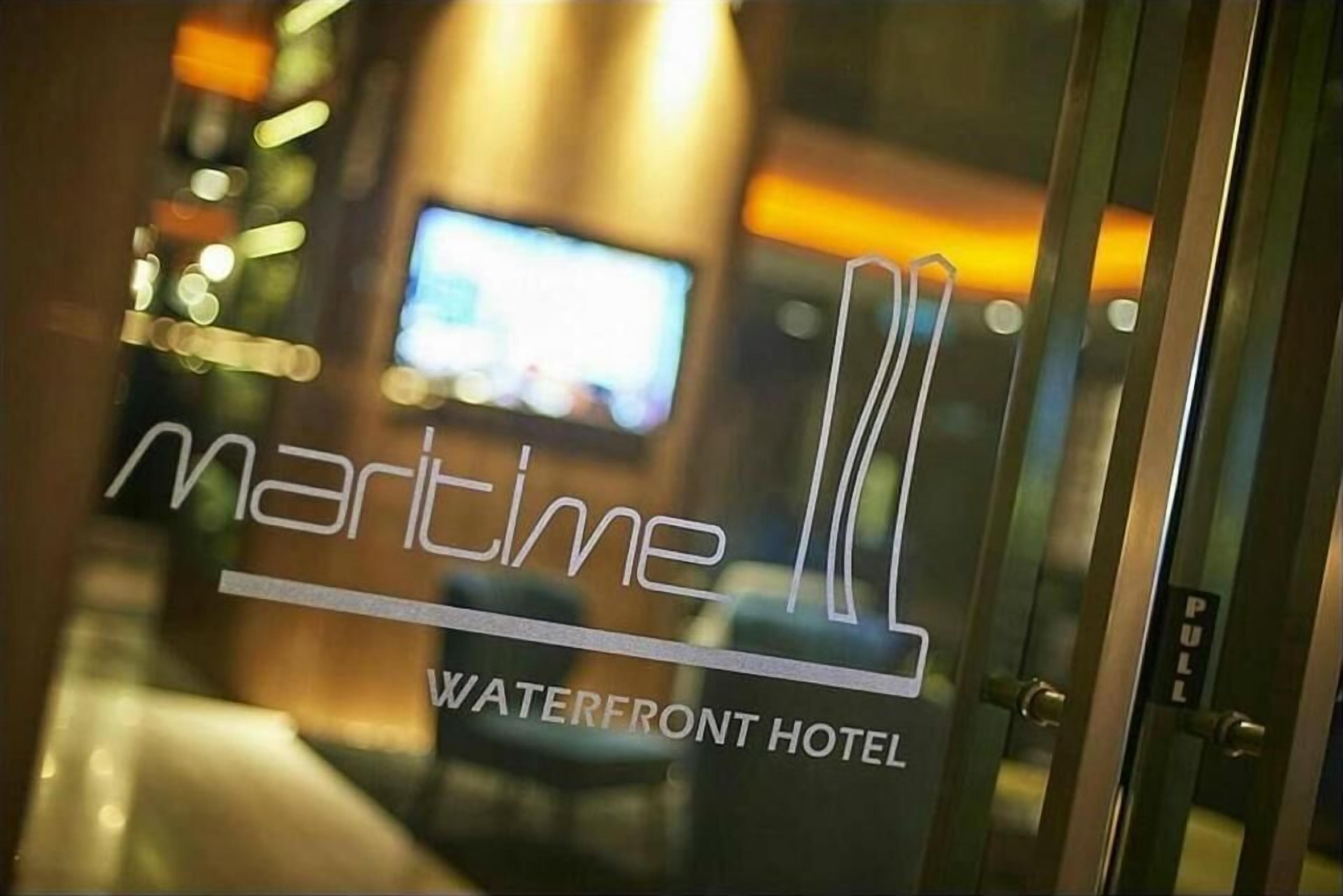 A hotel sign with the name "Maritime" and the tagline "Waterfront Hotel".