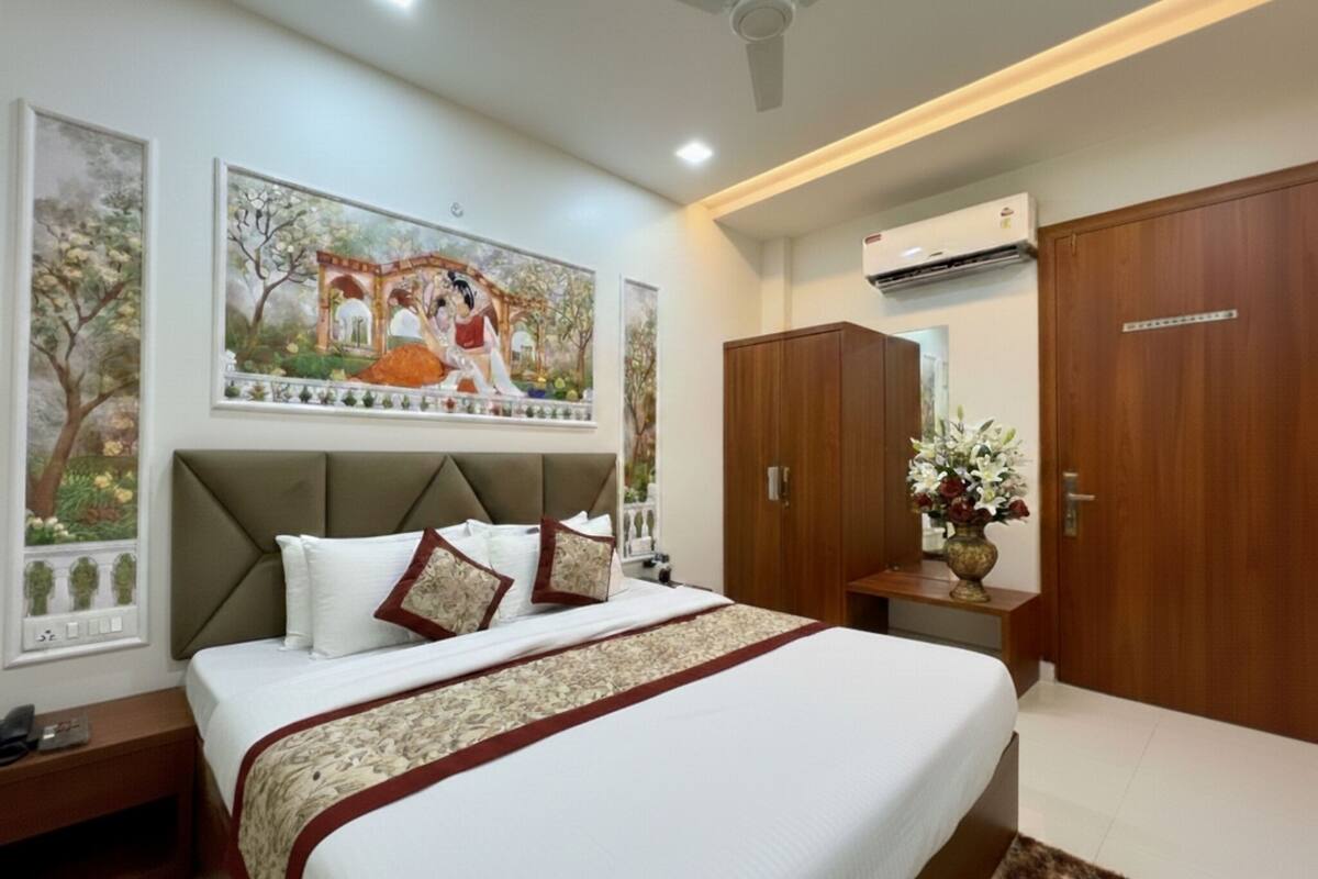 A bedroom with a bed, a nightstand, a wardrobe, and a ceiling fan.