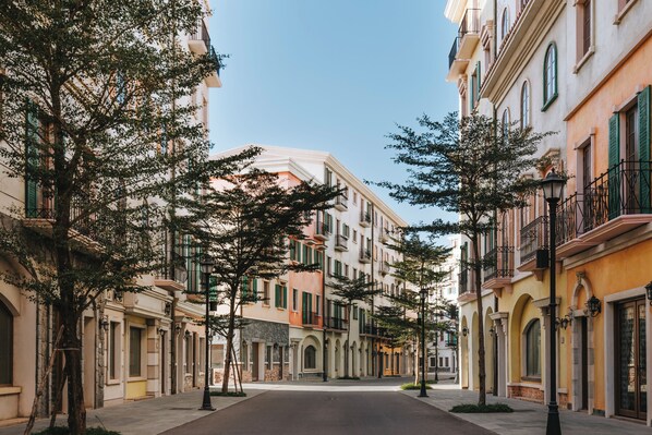 A street lined with multi-story buildings, featuring balconies and arched windows. - Rei Gallery Phu Quoc - Ocean (Phu Quoc)