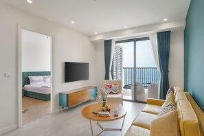 Deluxe Apartment, 2 Bedrooms, Balcony, Beach View | Living area | 50-inch flat-screen TV with cable channels - Rei Gallery Phu Quoc - Ocean (Phu Quoc)