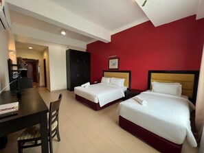 A hotel room with two beds, a desk, and a chair. - Pantai Puteri Hotel Malacca (Malacca City)