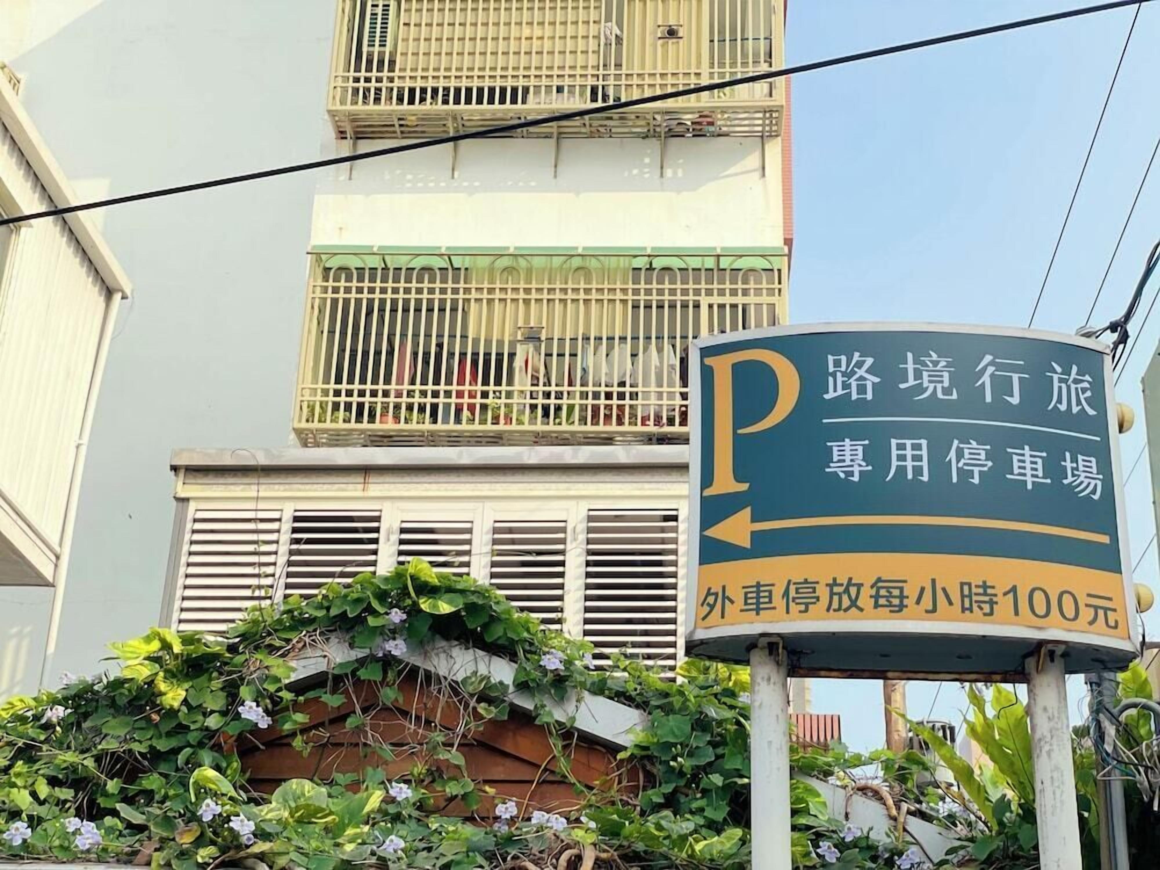 Un panneau indiquant une zone de stationnement où le tarif est de 100 yuans par heure pour le stationnement extérieur.