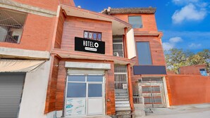 A hotel with a signboard, a large window, and a gated entrance. - Classic Hotel Siya Raman (Faizabad)