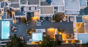 A rooftop hotel with multiple rooms, outdoor seating areas, and a swimming pool. - La Stella Hotel (Mykonos)