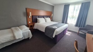 A hotel room with a large bed, a smaller bed, a desk, and a chair. - Premier Inn Middlesbrough South Guisborough (Guisborough)