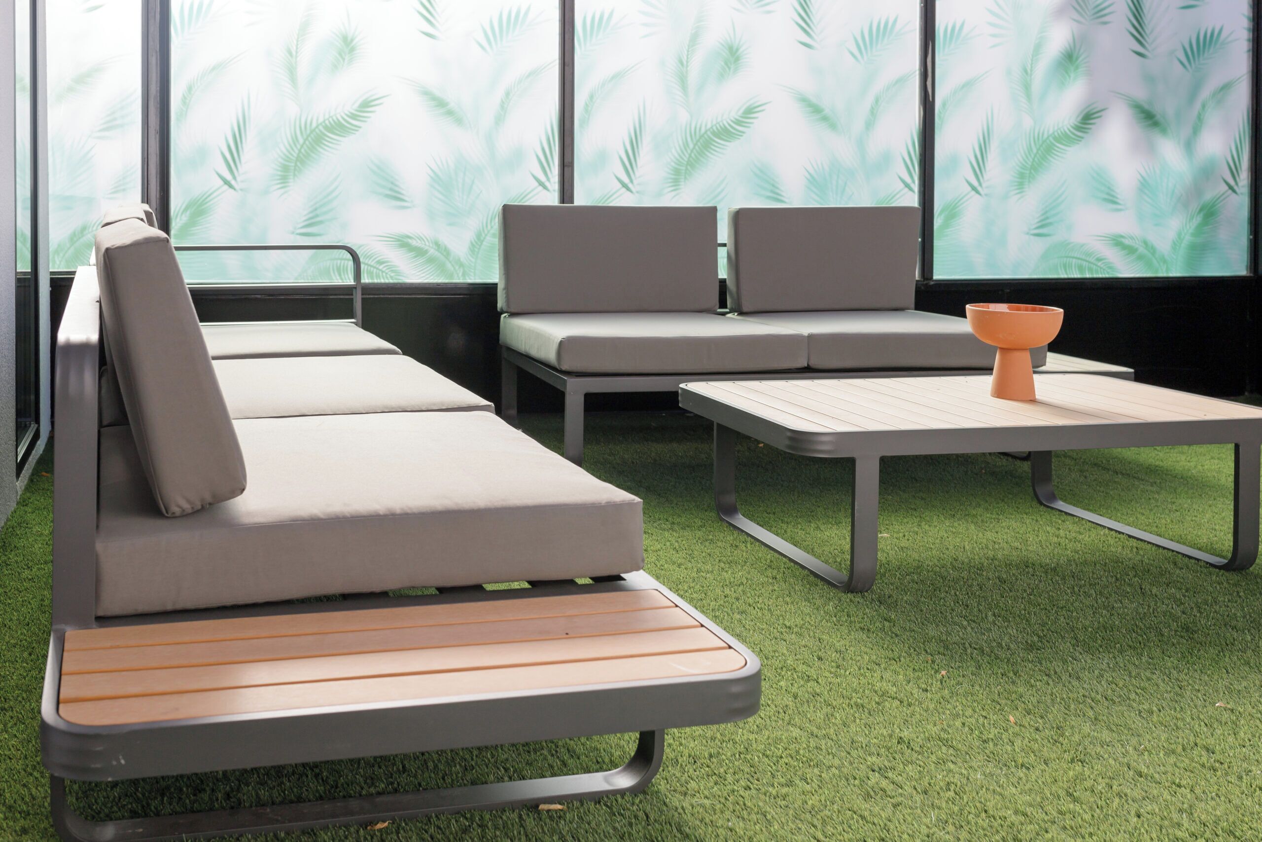 A modern lounge area with a sofa, a bench, and a table.