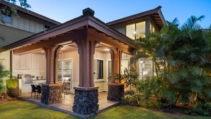 A house with a covered patio, stone pillars, and a kitchen area. - Kulalani at Mauna Lani Treasure w/ Beach Club Pass (Waimea)