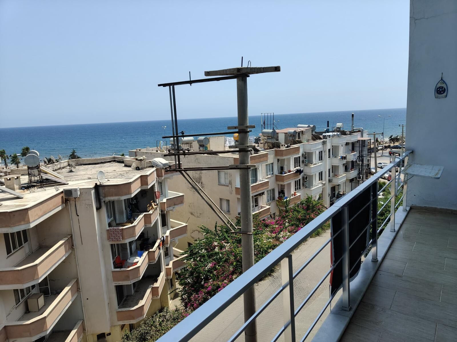 A residential building with multiple balconies overlooking a coastal area.
