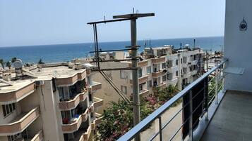 A residential building with multiple balconies overlooking a coastal area.
