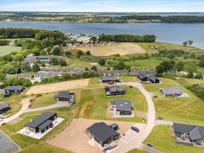 A residential area with houses and a large body of water in the background. - 5 Star Holiday Home in Aabenraa (Aabenraa)