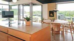 Una cucina moderna con un'isola grande, una televisione e un camino.