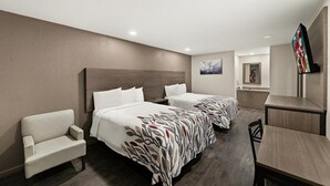 A hotel room with two beds, a sofa, a desk, and a TV. - Red Roof Inn Nacogdoches (Nacogdoches)