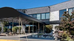 A modern building with a covered outdoor area, large windows, and a stone facade. - Quality Inn Carlisle (Carlisle)