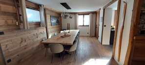 A wooden interior with a long dining table, chairs, and a ceiling light fixture. - L'Échappée Chalet sauna 7 bdrms terraces sublime view skiroom close to cable car (Champagny-en-Vanoise)