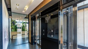 A modern elevator with a sign instructing to use stairs in case of fire. - Harbourline Haven | Signature #304 | De Waterkant (Cape Town)
