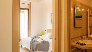 A bedroom with a bed, bedside table, and a window. - Villa Stone and Sea (Villa Almar) (Alghero)