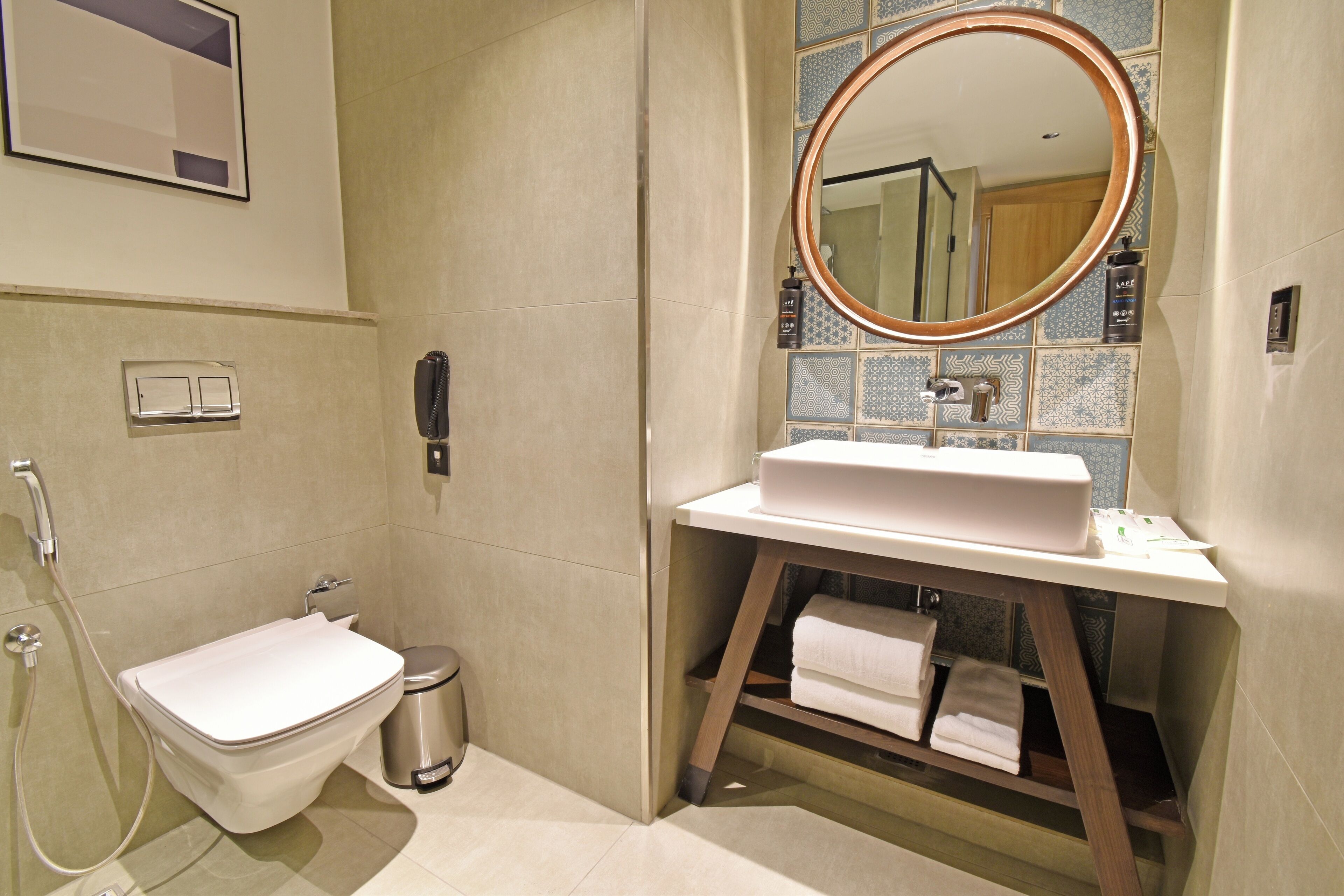 A modern bathroom with a toilet, bidet, and sink.