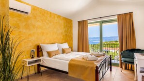A bedroom with a bed, bedside table, and a view of the outdoors. - Villa Isla Blue 1 pool&welness Krk by Villas Guide (Vrbnik)