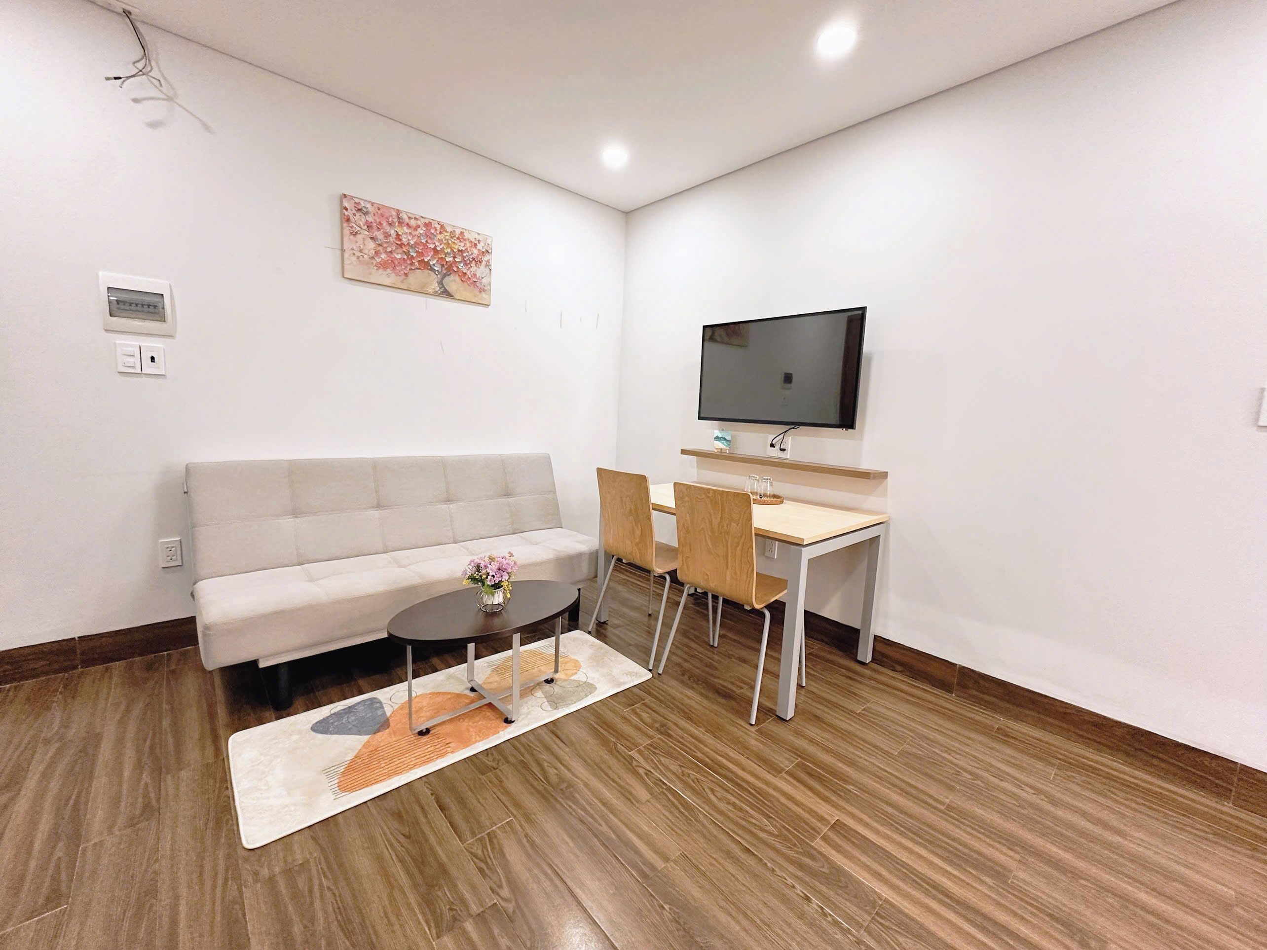 Deluxe Apartment, 1 Bedroom, Beach View | Living area | 60-inch Smart TV with satellite channels