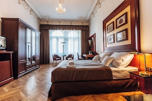 A hotel room with a large bed, a desk, a chair, and a wardrobe. - Hotel La Bohemia (Karlovy Vary)