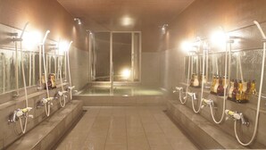 A public shower area with multiple showerheads and hand dryers. - Toki Resort Hakuba (Hakuba)
