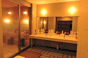A modern bathroom with two sinks, a large mirror, and a glass shower enclosure. - Toki Resort Hakuba (Hakuba)
