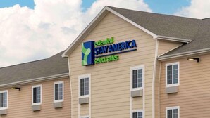 A hotel with a sign for Extended Stay America Select Suites.