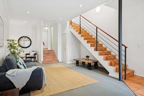 Living Comfortable lounge space with stylish decor and plenty of natural light. - The Bridgewalk | 2BR + Sofa Bed, Stadium & City (East Perth)