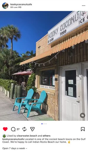 A restaurant named 'Kinky Coconut Food' with outdoor seating and a sign indicating 'CUBANS TACO HOTDOG'. - Steps 2 Sand | Magical Sunsets | Carefree Checkout (Indian Rocks Beach)