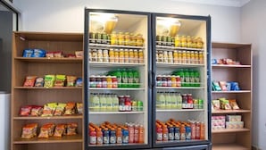 A refrigerated display case stocked with various beverages and snacks.