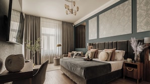 A modern bedroom with a large bed, a desk, and a chair. - White Lotus by Fragola Collection (Kraków)