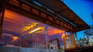 A modern building with large windows and a covered outdoor area. - The Cloud Resort (Kadugannawa)