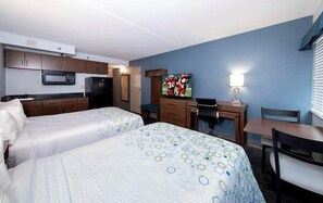 A hotel room with two beds, a kitchenette, a desk with a computer, a TV, and a window with blinds. - Extended Stay America - Washington DC - Chantilly (Chantilly)