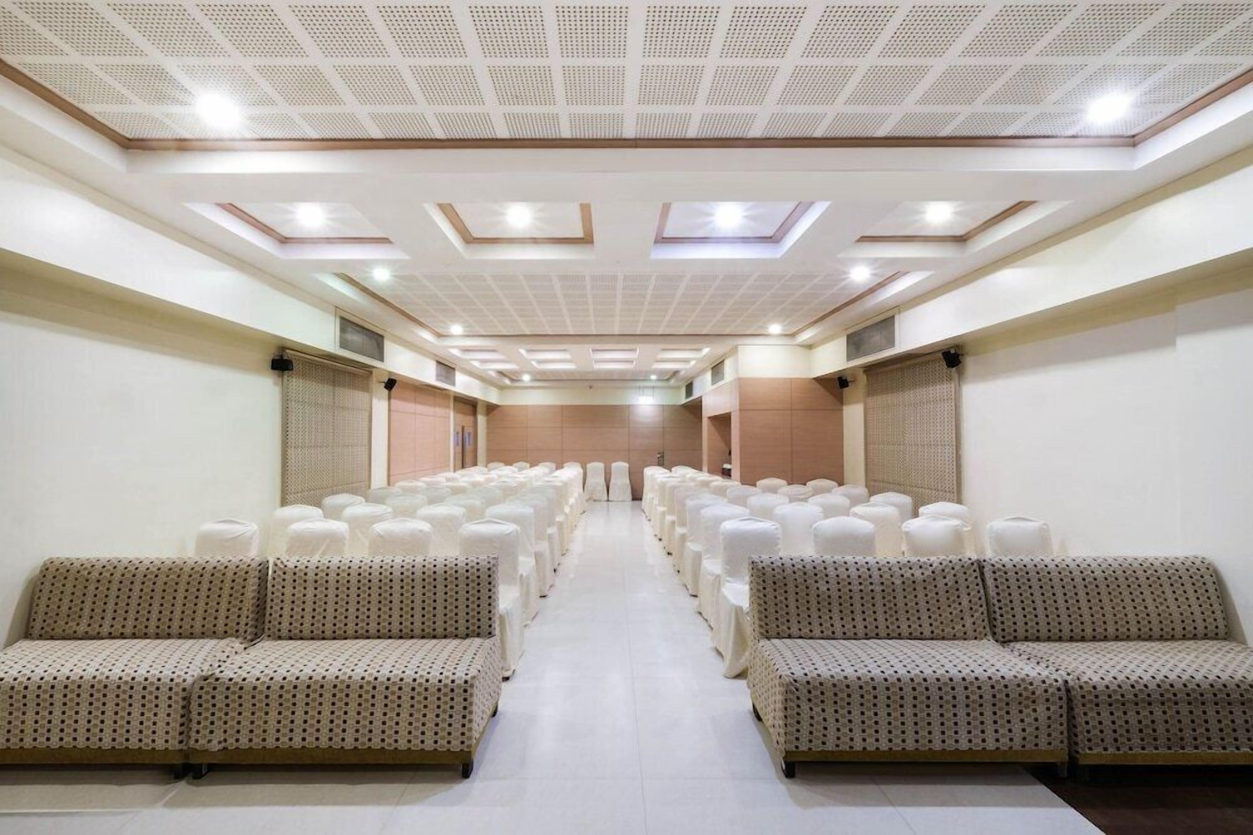 A hotel lobby with rows of seating and a central walkway.