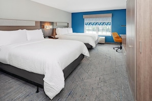 A hotel room with two beds, a desk, a chair, and a window with a view. - Port Wisconsin Inn and Suites (Port Washington)