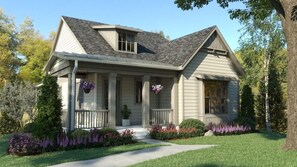 A two-story house with a front porch, a small attached garage, and a landscaped front yard with flowers and shrubs. - The Inns Of Geneva National (Lake Geneva)