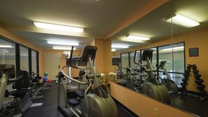 A gym with treadmills, elliptical machines, and free weights. - D. Hotel and Suites (Holyoke)