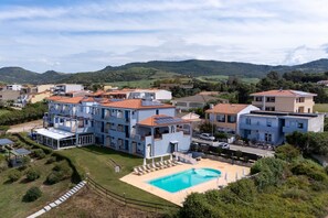 A residential complex with multiple buildings, a swimming pool, and a mountainous backdrop. - 'Con Balcone' Apartment with Sea View, Wi-Fi and Air Conditioning (La Muddizza)