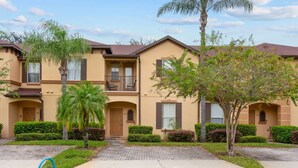 A row of two-story townhouses with balconies, a paved driveway, and well-maintained landscaping. - Tranquil Townhouse 3 bed Lazy River Resort (Davenport)