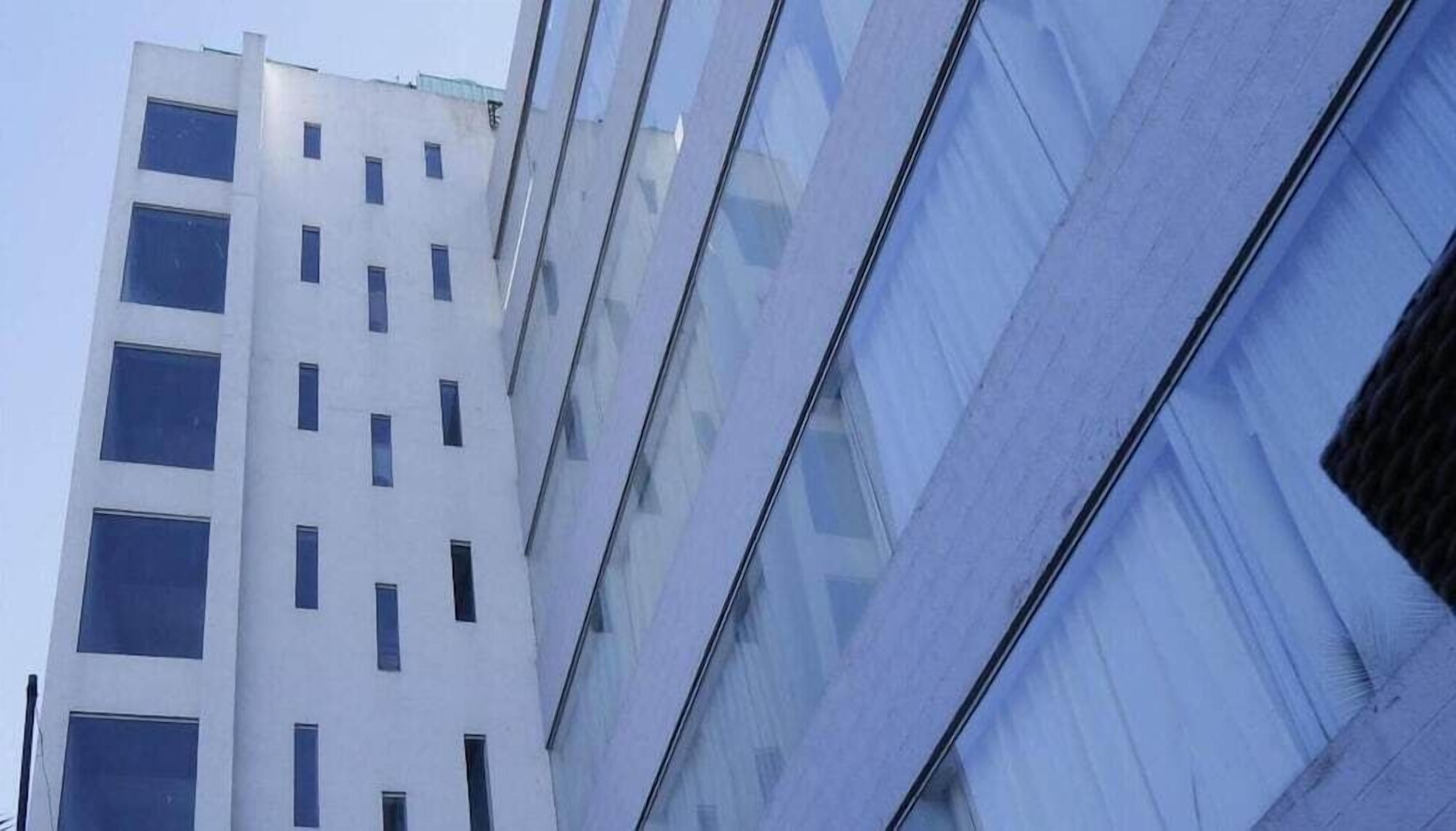 A modern building with multiple floors and large windows.