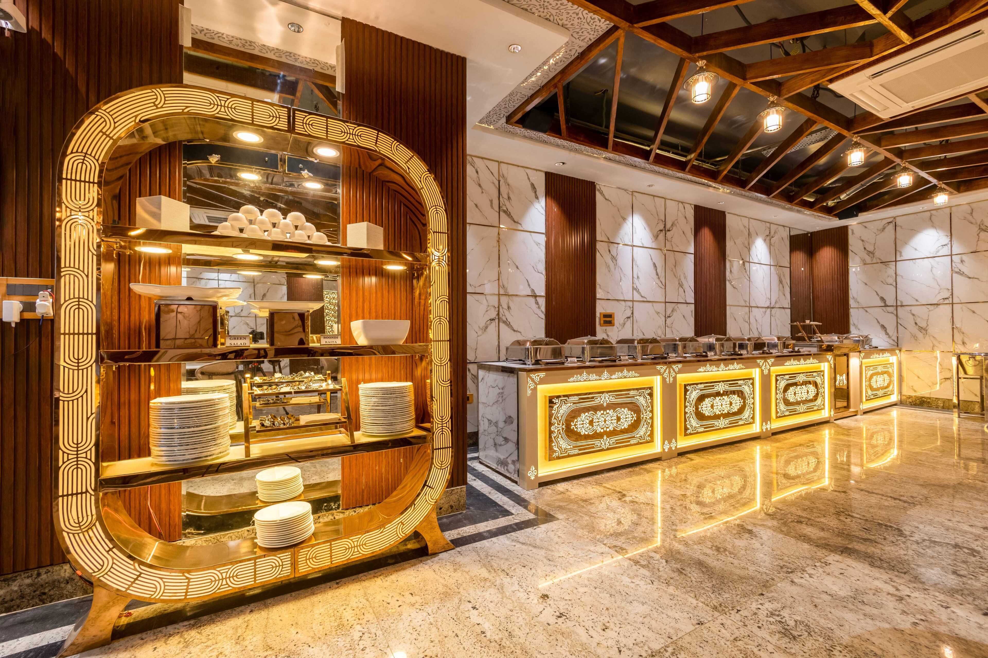 Un espace buffet luxueux, doté de plans de travail en marbre et d’une arche décorative.