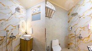 A bathroom with marble walls, a sink, a toilet, and a shower area. - Hotel Silver Star (Greater Noida)