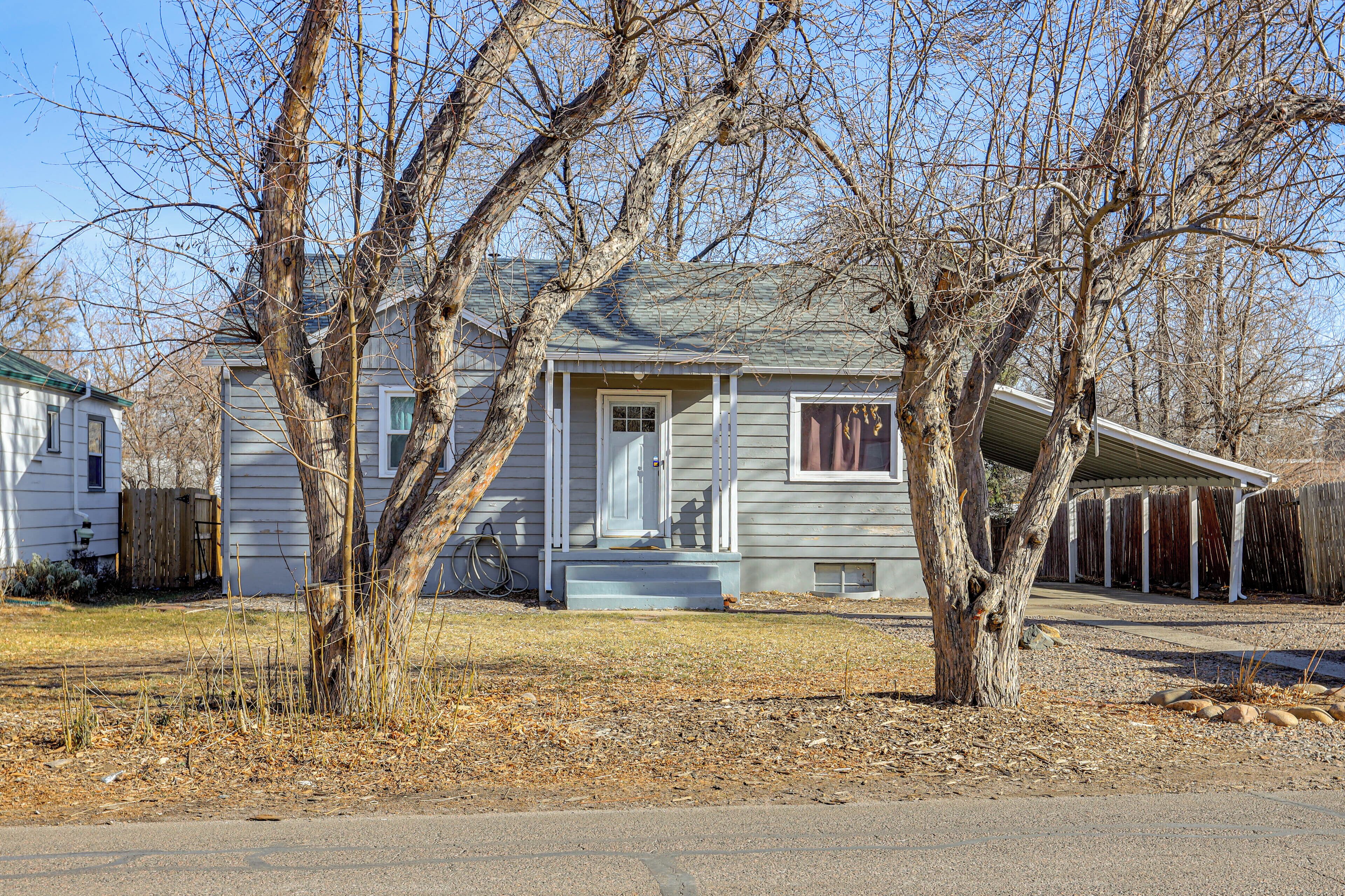 A single-story house with a front porch, a garage, and a covered patio area.