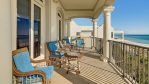 A balcony with wicker furniture and a view of the ocean. - 'like No Other' in the Panhandle of Florida (Panama City Beach)