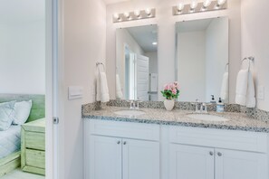 A bathroom with a double sink, vanity, and a large mirror with lights. - Nurse-ready Rental 2 Mi to UWF Campus & Hospital! (Pensacola)